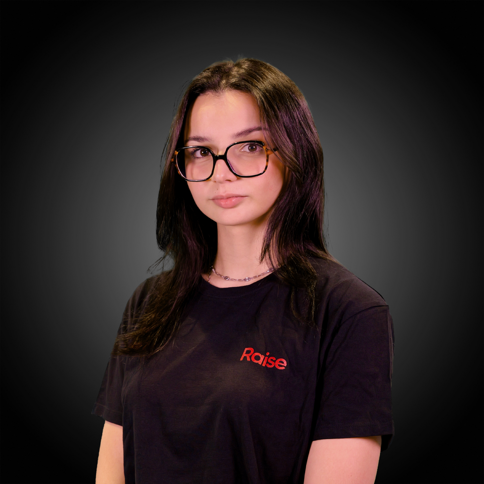 Lola wearing the black Raise Tshirt