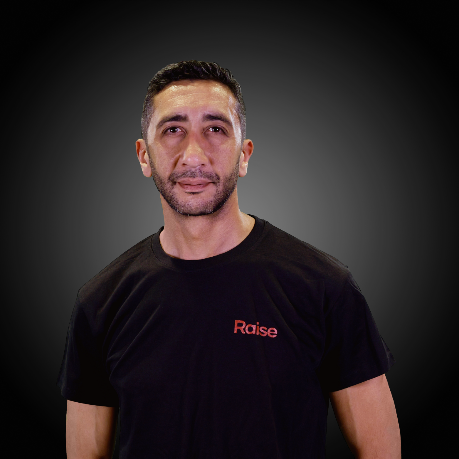 Sofiane wearing the black Raise Tshirt