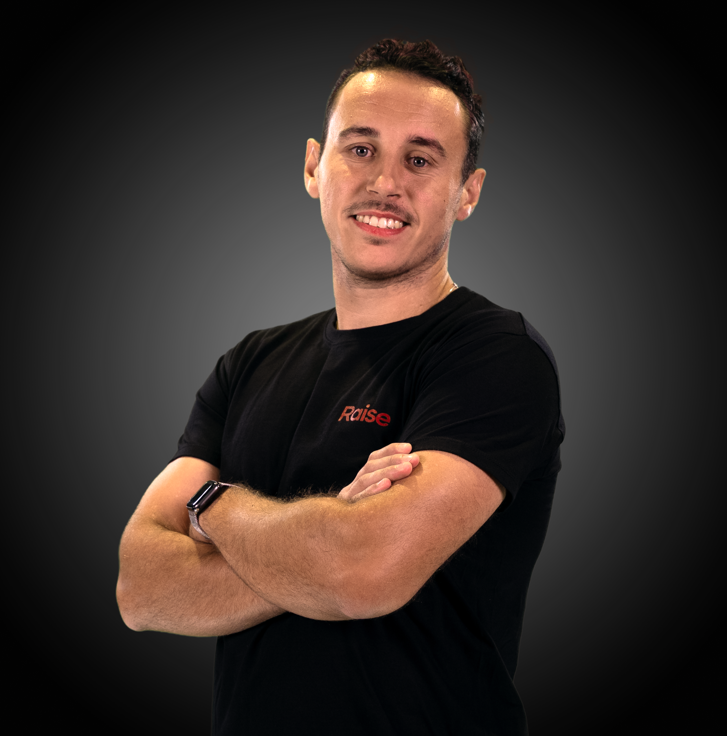 Antoine wearing the black Raise Tshirt