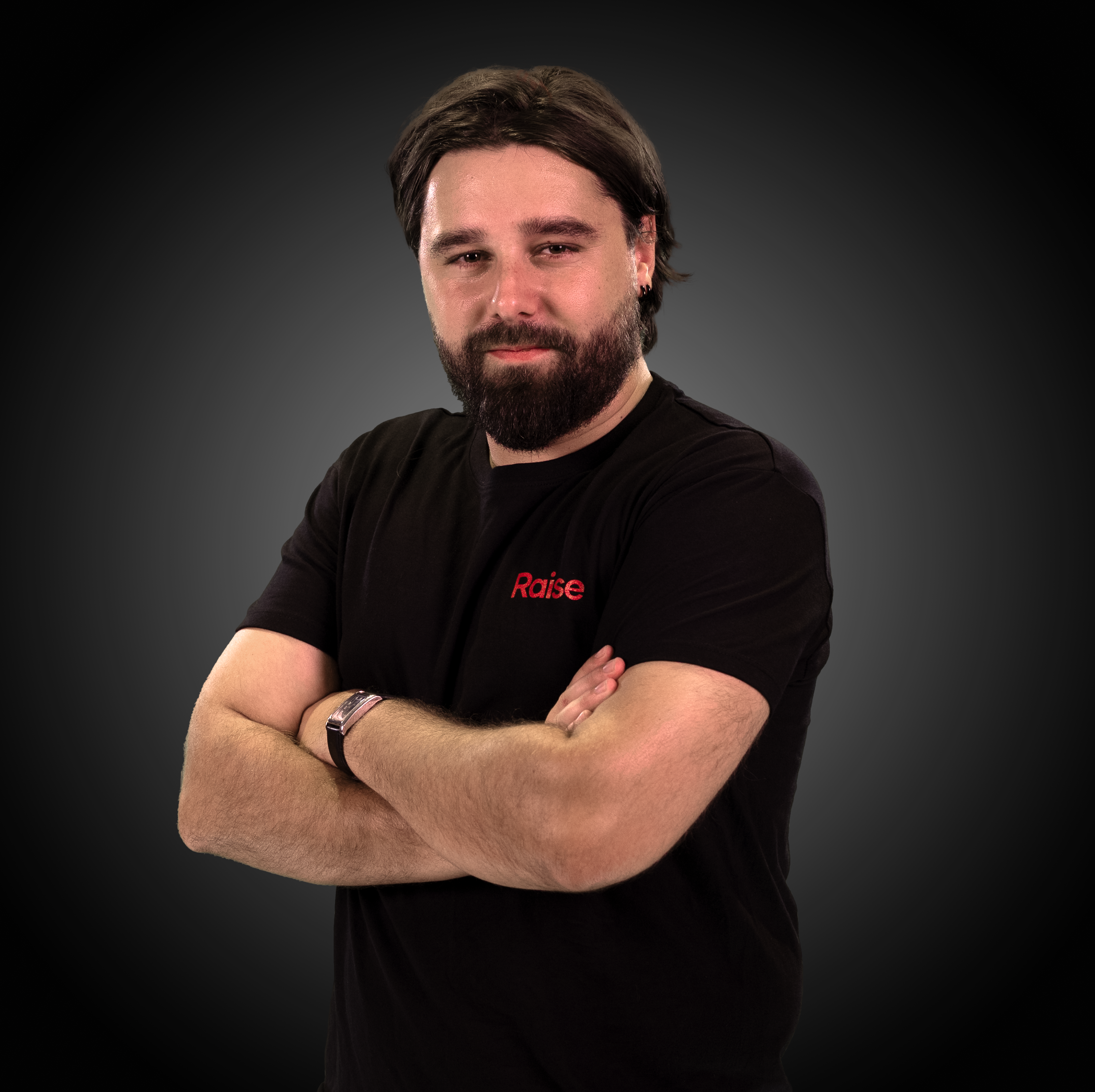 Hugo wearing the black Raise Tshirt