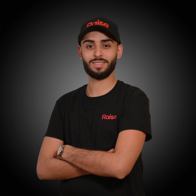 Hassen wearing the black Raise Tshirt